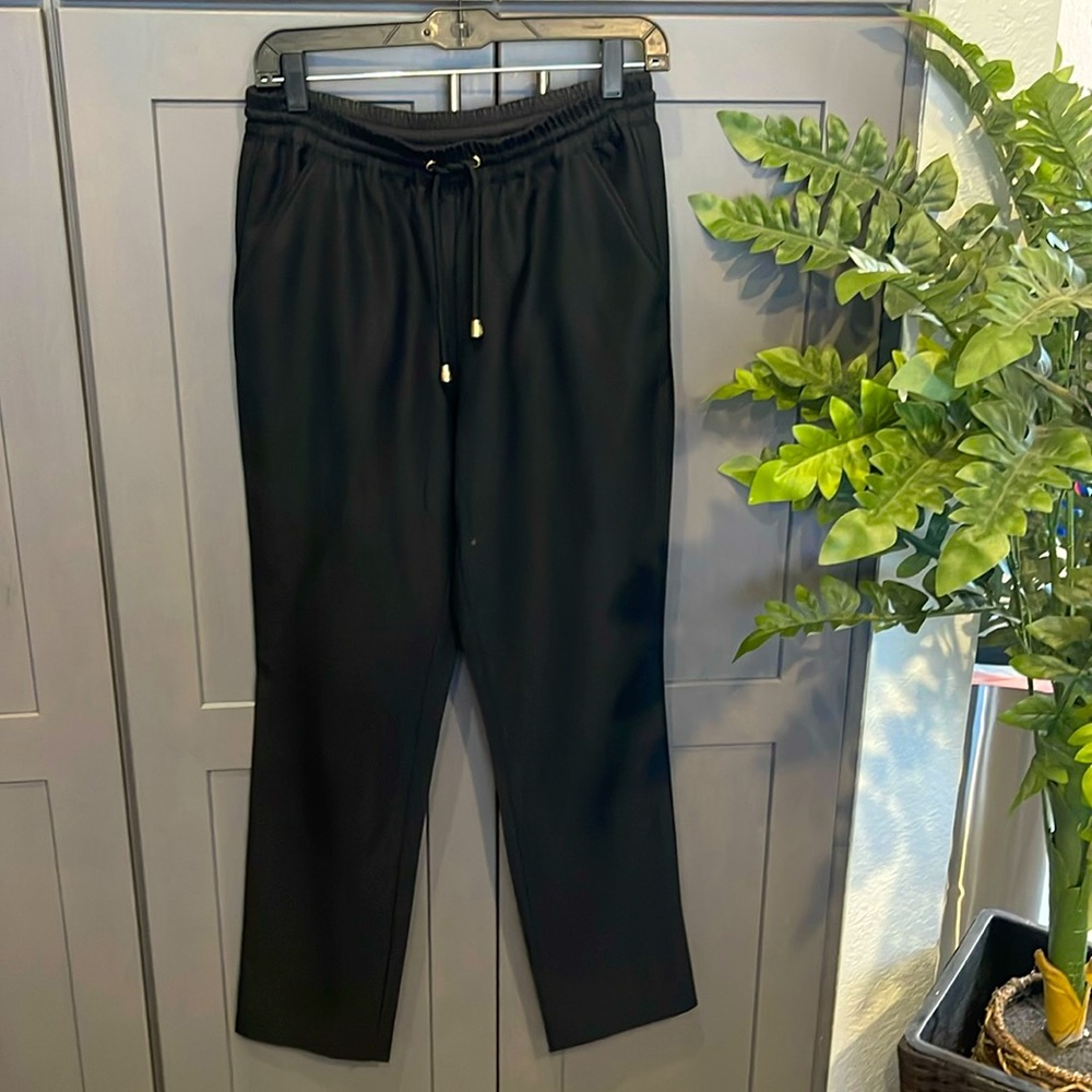 Dress pants with stretchy waist band and thin drawstring. Ankle fit and worn.